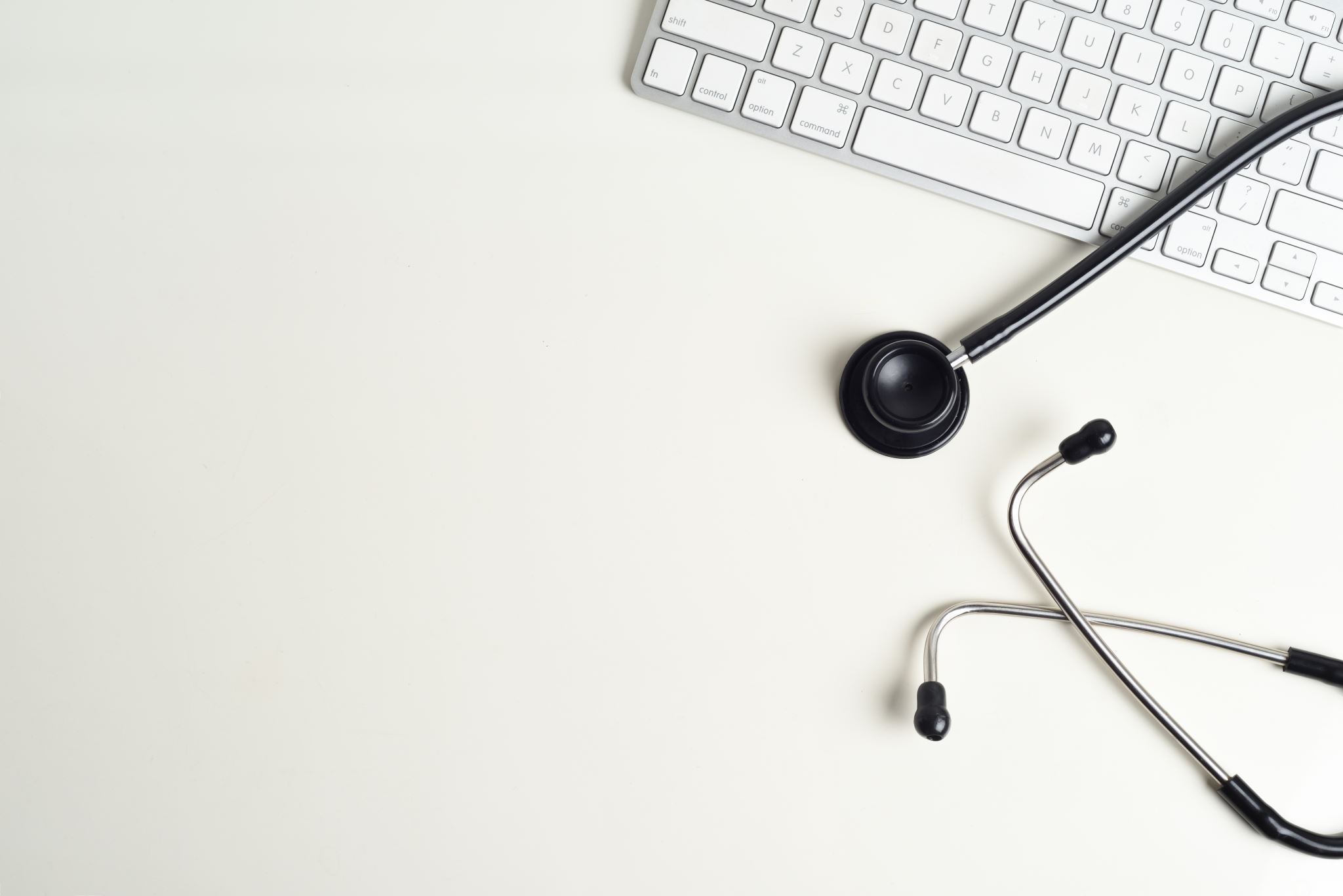 Desk-with-stethoscope-and-computer-keyboard